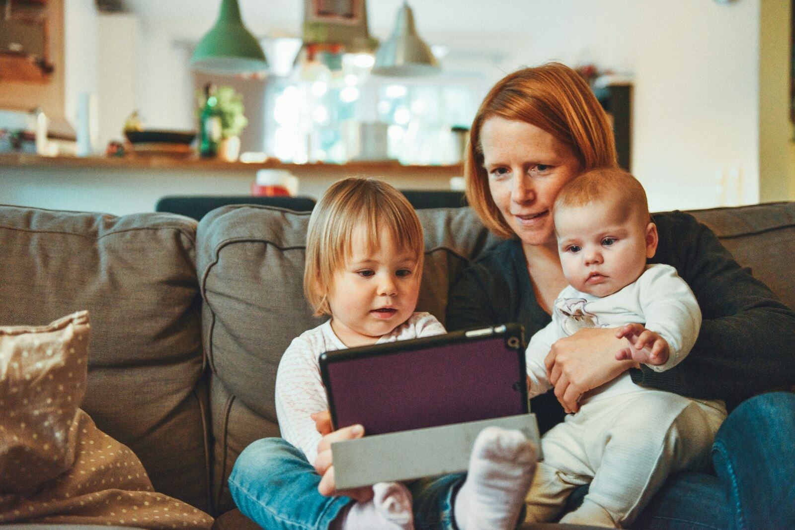Mother with her two young children at home